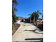 Charming home featuring a well-manicured lawn, palm trees, and a driveway leading to the front door at 3800 Belle Vista E Dr, St Pete Beach, FL 33706