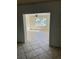 Living room with tile flooring and view through a large window at 3800 Belle Vista E Dr, St Pete Beach, FL 33706