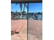 Patio view showcasing waterfront scenery with damaged dock, reflected in sliding glass doors at 3800 Belle Vista E Dr, St Pete Beach, FL 33706