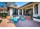 Backyard view of sitting area, covered patio, and lush lawn at 4605 Skimmer S Way, St Petersburg, FL 33711