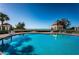 Inviting pool reflecting blue sky and elegant poolside gazebos, surrounded by lush greenery and lounge chairs at 4605 Skimmer S Way, St Petersburg, FL 33711