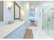 Bright bathroom featuring marble floors, glass shower, and quartz countertop vanity at 4614 River Overlook Dr, Valrico, FL 33596