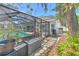 Exterior view of a screened-in pool area, showcasing the home's backyard layout and landscaping at 4614 River Overlook Dr, Valrico, FL 33596