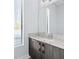 Modern bathroom featuring gray vanity with white counter and natural light at 4810 W Mcelroy Ave # 7, Tampa, FL 33611