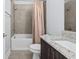 Bathroom with modern vanity with granite countertop, and a tub/shower combo with tile surround at 4810 W Mcelroy Ave # 7, Tampa, FL 33611