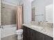 Bathroom with modern vanity with granite countertop, and a tub/shower combo with tile surround at 4810 W Mcelroy Ave # 7, Tampa, FL 33611