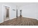 Spacious bedroom with wood floors and doors leading to a bathroom, closet, and stairway at 4810 W Mcelroy Ave # 7, Tampa, FL 33611