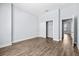 Empty bedroom features wood-look floors, closet, and a connecting door to other rooms at 4810 W Mcelroy Ave # 7, Tampa, FL 33611