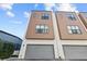 Modern townhome featuring a two-car garage and neutral exteriors at 4810 W Mcelroy Ave # 7, Tampa, FL 33611
