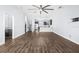 Open-concept living room with wood floors and view of modern kitchen and stairs at 4810 W Mcelroy Ave # 7, Tampa, FL 33611