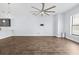 Open-concept living room with wood floors and view of modern kitchen and windows at 4810 W Mcelroy Ave # 7, Tampa, FL 33611