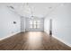 Spacious living room featuring wood-look flooring and a modern light fixture at 4810 W Mcelroy Ave # 7, Tampa, FL 33611