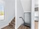 Staircase view features natural light and wood-look floors for a modern, stylish design element at 4810 W Mcelroy Ave # 7, Tampa, FL 33611