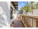 Outdoor walkway with wooden railing and a peaked metal awning at 4810 W Mcelroy Ave # 7, Tampa, FL 33611
