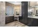 Bathroom featuring dark wood cabinets, quartz countertops, and unique glass block window for natural light at 4951 Bacopa S Ln # 801, St Petersburg, FL 33715