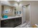 Modern bathroom with a dark wood vanity, quartz countertop, and decorative accents at 4951 Bacopa S Ln # 801, St Petersburg, FL 33715