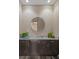 Stylish powder room with dark cabinets, granite countertop, modern mirror and decorative accents at 4951 Bacopa S Ln # 801, St Petersburg, FL 33715
