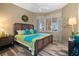 Cozy bedroom with a decorative wreath, a large bed, and scenic outdoor views from the window at 4951 Bacopa S Ln # 801, St Petersburg, FL 33715