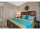 Well-lit bedroom features a comfortable bed, neutral walls, a decorative wreath, and hardwood floors at 4951 Bacopa S Ln # 801, St Petersburg, FL 33715