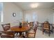 Elegant dining room with stylish furniture, decorative plants, and bright natural light from shuttered windows at 4951 Bacopa S Ln # 801, St Petersburg, FL 33715