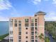 Exterior view of condo featuring multiple balconies with stunning waterfront views and convenient parking at 4951 Bacopa S Ln # 801, St Petersburg, FL 33715