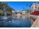 Beautiful community clubhouse with a fountain, landscaping, and water feature in a tropical setting at 4951 Bacopa S Ln # 801, St Petersburg, FL 33715