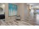 Hallway featuring modern flooring, elegant wall decor, and access to bathroom and living areas at 4951 Bacopa S Ln # 801, St Petersburg, FL 33715