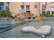 Unique community waterfall feature with tropical foliage and whimsical turtle statue at 4951 Bacopa S Ln # 801, St Petersburg, FL 33715