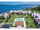 Stunning aerial view of waterfront condos with beautiful landscaping and a sparkling community pool at 50 Coe Rd # 223, Belleair, FL 33756