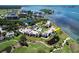 Waterfront condo surrounded by lush greenery, a pool, and serene water features, unit is highlighted in yellow at 50 Coe Rd # 223, Belleair, FL 33756