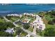 Aerial view of waterfront condos with a pool, golf course and ocean views in the background at 50 Coe Rd # 223, Belleair, FL 33756