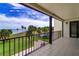 Relaxing outdoor balcony boasting stunning waterfront views, palm trees, and manicured lawns at 50 Coe Rd # 223, Belleair, FL 33756