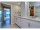 Dual sink bathroom with white cabinets and tile flooring at 50 Coe Rd # 223, Belleair, FL 33756