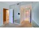 Bedroom with carpet and mirrored wall leading to the bathroom and closet at 50 Coe Rd # 223, Belleair, FL 33756