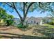 Large shady backyard offers a relaxing view and screened-in pool at 503 Old Grove Dr, Lutz, FL 33548