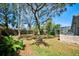 A view of the big backyard features a brick grill and screened-in pool at 503 Old Grove Dr, Lutz, FL 33548