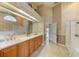 Bathroom featuring a double vanity with brown cabinetry, shower, and tub at 503 Old Grove Dr, Lutz, FL 33548