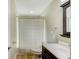 Bathroom includes a vanity, decorative shower curtain and tile floor at 503 Old Grove Dr, Lutz, FL 33548