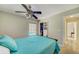 This bedroom offers a ceiling fan, closet and view to another area at 503 Old Grove Dr, Lutz, FL 33548