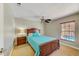 Comfortable bedroom features a ceiling fan and a window for natural light at 503 Old Grove Dr, Lutz, FL 33548