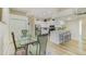 Dining room with glass table, kitchen, and breakfast bar at 503 Old Grove Dr, Lutz, FL 33548