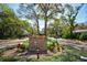 Entrance to Crystal Lakes Manor featuring lush landscaping and a welcoming sign at 503 Old Grove Dr, Lutz, FL 33548