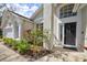 Home's black front door and large front windows framed by well-manicured landscaping at 503 Old Grove Dr, Lutz, FL 33548