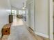 Hallway with wooden floors, neutral walls, and view into the living room at 503 Old Grove Dr, Lutz, FL 33548