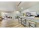 Well-lit kitchen with bar seating, stainless steel appliances, and an adjacent dining area at 503 Old Grove Dr, Lutz, FL 33548