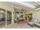 Covered patio with stylish wicker seating, a ceiling fan, a mounted TV, and views of the landscaped backyard at 503 Old Grove Dr, Lutz, FL 33548