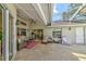 Covered patio with comfortable seating, a red patterned rug, and views of the backyard at 503 Old Grove Dr, Lutz, FL 33548