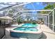 Inviting screened pool and spa area with ample space for relaxation and dining, perfect for outdoor entertaining at 503 Old Grove Dr, Lutz, FL 33548
