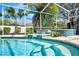 A screened-in pool features spa steps, water features and mature landscaping at 503 Old Grove Dr, Lutz, FL 33548