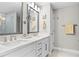 Elegant bathroom with double vanity, modern fixtures, and well-lit mirrors at 5351 Bridge St # 41, Tampa, FL 33611